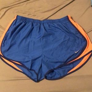 Blue Nike shorts with neon orange trim. XL